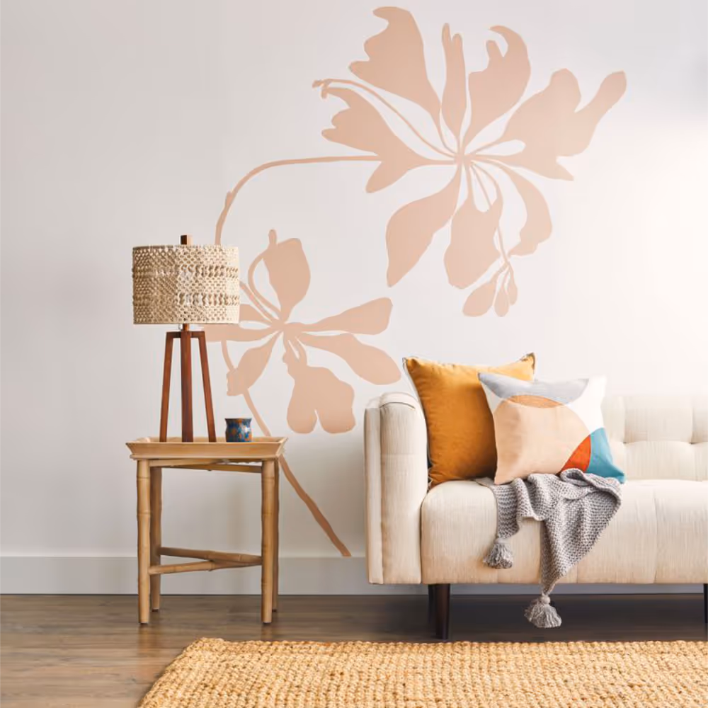 A striking blush pink floral mural on a white wall